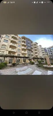 a large apartment building with umbrellas in front of it at Florienza resort in Hurghada
