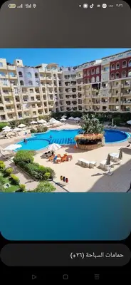 a view of a large apartment complex with a swimming pool at Florienza resort in Hurghada