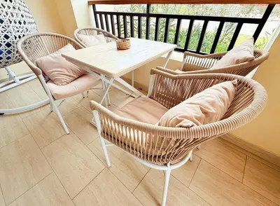 a porch with a table and chairs on a balcony at Hotel Apartment 1 very nice and quiet hurghada in Hurghada