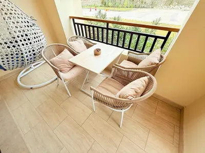 a patio with a table and chairs and a balcony at Hotel Apartment 1 very nice and quiet hurghada in Hurghada
