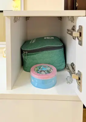 a green suitcase is sitting on a shelf at Hotel Apartment 1 very nice and quiet hurghada in Hurghada