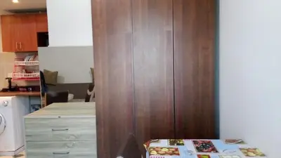 a kitchen with a large wooden cabinet in a kitchen at princess resort ,arch angilos Hurghada in Hurghada