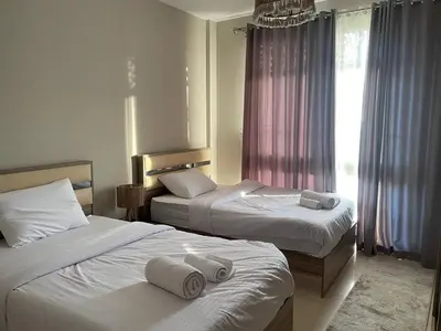 two beds in a hotel room with towels on them at Luxury 5 Bedrooms Sea Front Villa in Hurghada