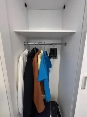 a closet with a bunch of clothes hanging on a rack at Aqua Infinity Oasis walking distance to beach, 15 minutes from El Gouna, 15 minutes from central Hurghada in Hurghada