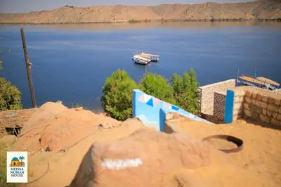 a boat in a large body of water at Heissa Nubian Hostel in Aswân Reservoir Colony