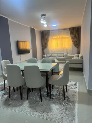 a dining room with a table and chairs and a couch at Inter Prime apartment 1 in Hurghada