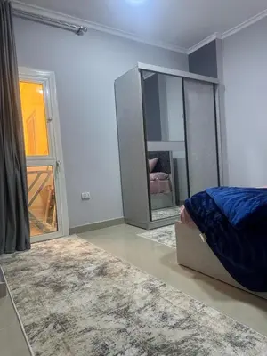 a bedroom with a bed and a large mirror at Inter Prime apartment 1 in Hurghada
