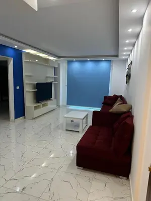 a living room with a couch and a tv at 005 flamingo building Cozy appartement-two beds-1st floor with elevator in Hurghada