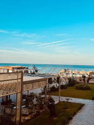 a view of the beach from the balcony of a resort at 005 flamingo building Cozy appartement-two beds-1st floor with elevator in Hurghada