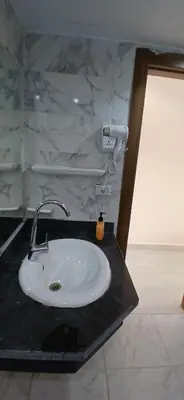 a white sink in a bathroom with a marble wall at Lilyland Beach Resort & Waterpark in Hurghada