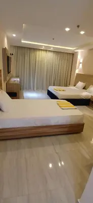two beds in a hotel room with two beds at Lilyland Beach Resort & Waterpark in Hurghada