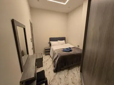 a small bedroom with a bed and a mirror at Dive Hostel Hurghada Sea Light in Hurghada