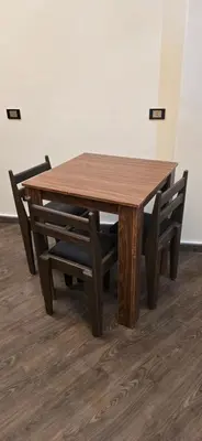 a wooden table with two chairs around it at Dive Hostel Hurghada Sea Light in Hurghada