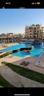 a large swimming pool in a city with buildings at Modern apartment in Hurghada al dau heights 3314 in Hurghada