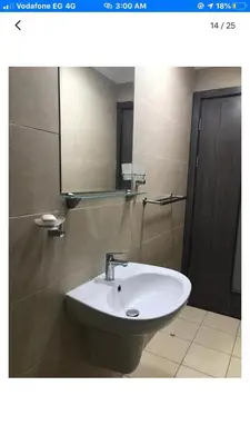 a bathroom with a white sink and a mirror at Modern apartment in Hurghada al dau heights 3314 in Hurghada