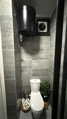 a bathroom with a toilet and a black tank at Imperial Resort Hurghada in Hurghada