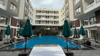 a swimming pool in the middle of a building with umbrellas at Imperial Resort Hurghada in Hurghada
