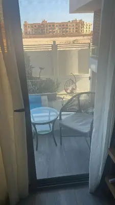 a balcony with two chairs and a table and a view at Imperial Resort Hurghada in Hurghada
