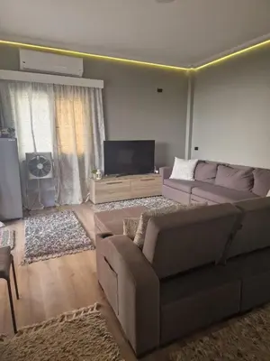 a living room with a couch and a flat screen tv at Apartment for rent 2 bed rooms in Hurghada