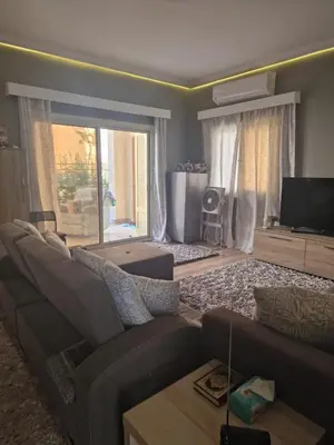 a living room with a couch and a television at Apartment for rent 2 bed rooms in Hurghada