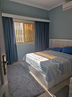 a bedroom with a bed and a window at Apartment for rent 2 bed rooms in Hurghada