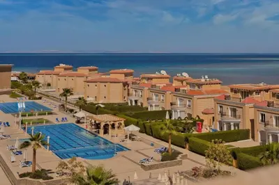 a view of a resort with a pool and the ocean at Selena Bay Resort in Hurghada