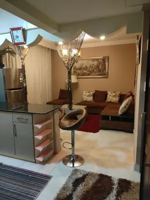 a kitchen and living room with a counter and a stool at Apartment for rent in Hurghada