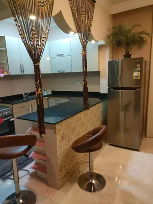 a kitchen with a counter and two bar stools at Apartment for rent in Hurghada