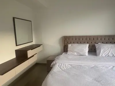 a bedroom with a white bed and a mirror at G Cribs Hotel Apartment 2BR in Hurghada