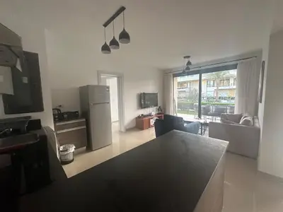 a kitchen with a refrigerator and a living room at G Cribs Hotel Apartment 2BR in Hurghada