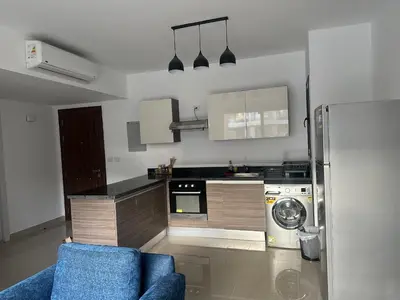 a kitchen with a blue couch and a refrigerator at G Cribs Hotel Apartment 2BR in Hurghada