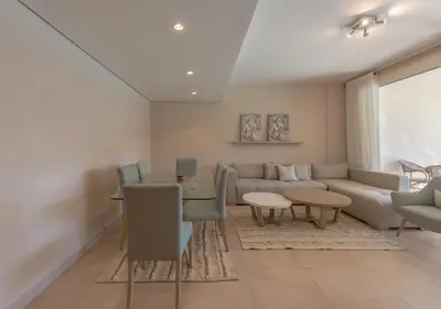 a living room with a couch and a table at Sea View 2BR Mangroovy Gouna I Swimming Pool and Red Sea Beach in Hurghada