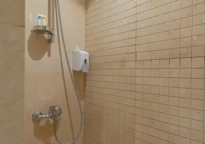 a shower with a shower head in a bathroom at Sea View 2BR Mangroovy Gouna I Swimming Pool and Red Sea Beach in Hurghada