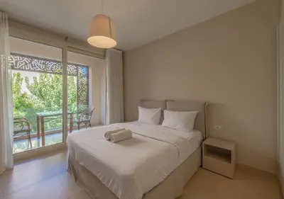 a bedroom with a bed and a large window at Sea View 2BR Mangroovy Gouna I Swimming Pool and Red Sea Beach in Hurghada