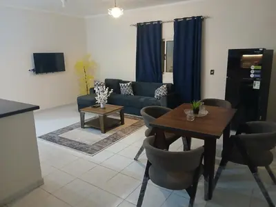 a living room with a table and a couch at Cozy Apartment in Hurghada