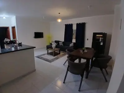 a living room with a table and a couch at Cozy Apartment in Hurghada