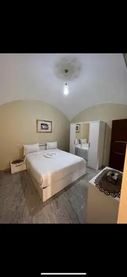 a bedroom with a large white bed in it at Palace view in Hurghada