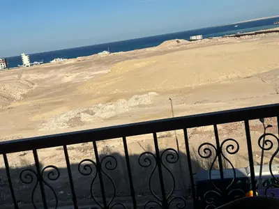 a view of a sandy beach from a balcony at Palace view in Hurghada