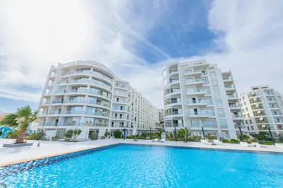 two large apartment buildings with a swimming pool at Scandic Resort Hurghada مبني سكندك رزوت الغردقة in Hurghada