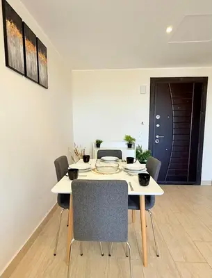 a dining room with a white table and chairs at Luxury hotel apartment 2rooms with triple sea view in Hurghada