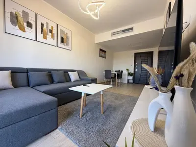 a living room with a blue couch and a table at Luxury hotel apartment 2rooms with triple sea view in Hurghada