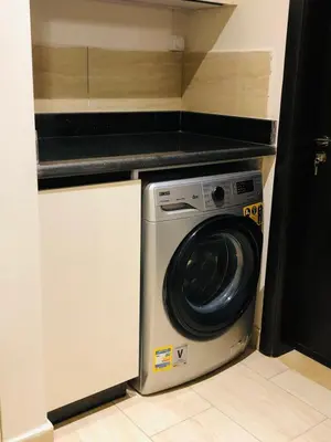 a washer and dryer in a small kitchen at Luxury hotel apartment 2rooms with triple sea view in Hurghada