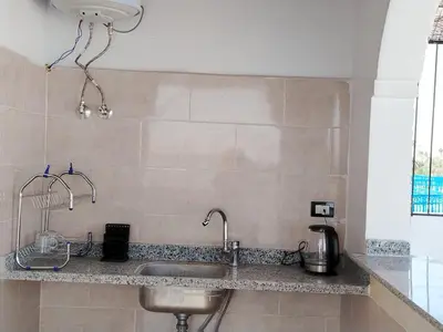 a kitchen with a sink and a counter top at Mena Palace Nile View in Luxor