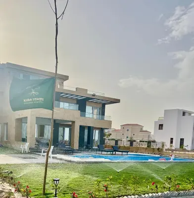 a building with a swimming pool in front of it at Villa KUBA luxury in Hurghada