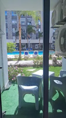 a view of a patio with a table and chairs at Fanadir Bay apartment in Hurghada