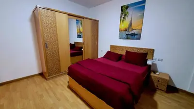 a bedroom with a large bed with purple sheets at touristic centre hurghada in Hurghada