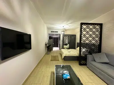 a living room with a couch and a tv at Golden Aldau Heights studio Hurghada 1019 in Hurghada