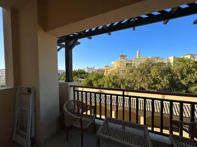 a balcony with chairs and a view of the city at Golden Aldau Heights studio Hurghada 1019 in Hurghada