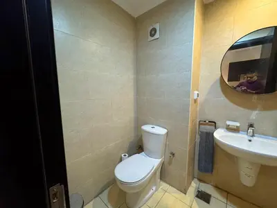 a bathroom with a toilet and a sink and a mirror at Golden Aldau Heights studio Hurghada 1019 in Hurghada