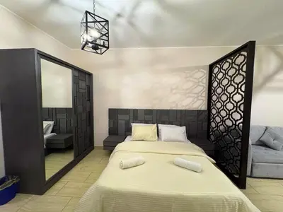 a bedroom with a large bed and a mirror at Golden Aldau Heights studio Hurghada 1019 in Hurghada